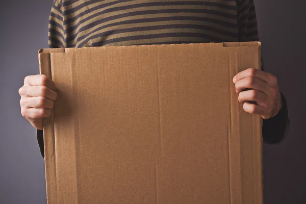 Man holding cardboard copy space — Stock Photo, Image