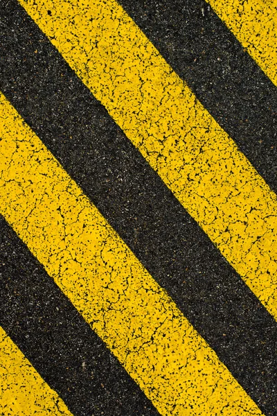 Yellow striped road markings on black asphalt. — Stock Photo, Image