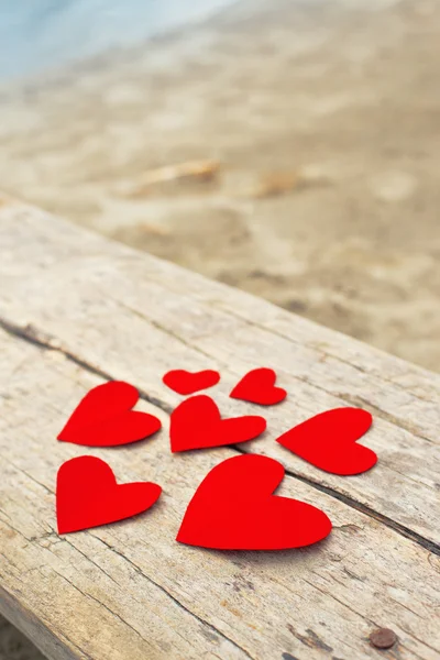 Red paper hearts on grunge wooden background — Stock Photo, Image