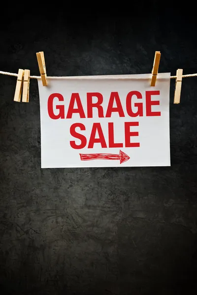 Garage Sale sign hanging on clothes rope — Stock Photo, Image