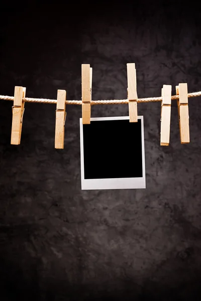 Photography paper with instant photo frame attached to rope with — Stock Photo, Image