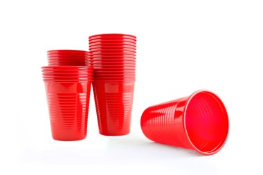 Plastic red cups on white background clipart