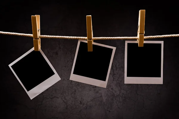 Photography paper with instant photo frames attached to rope wit — Stock Photo, Image