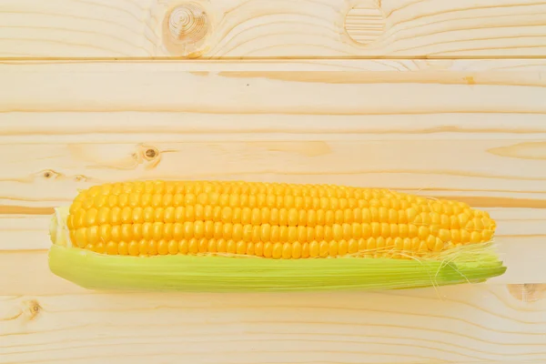 Corn Cob on wooden table — Stock Photo, Image