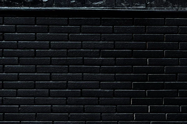 Background of black brick wall, dark pattern and urban texture