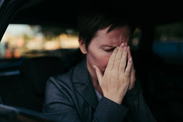 坐在车内焦虑的女商人 坐在汽车后座上焦虑而紧张的女企业家 — 图库照片