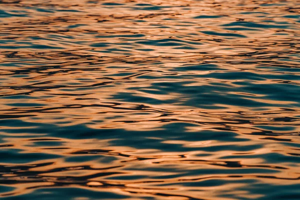 Pęknięta Powierzchnia Błękitnej Wody Morskiej Odcieniach Słońca Pomarańczy Cytrusów Ostrość — Zdjęcie stockowe