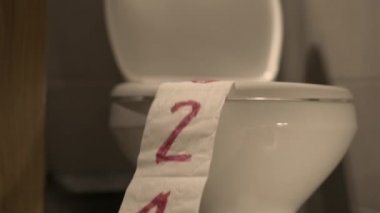 Ending 2021, humorous footage of paper roll being sucked into sanitary toilet after flushing water, slow motion