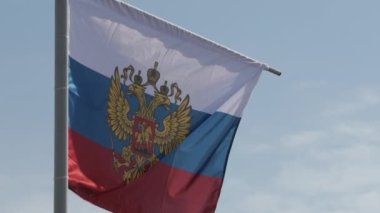 Russian flag with the coat of arms, two-headed eagle without the shield, slow motion