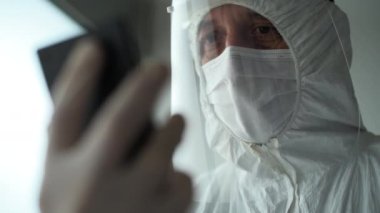 Medical professional during video call on smartphone, close up with selective focus