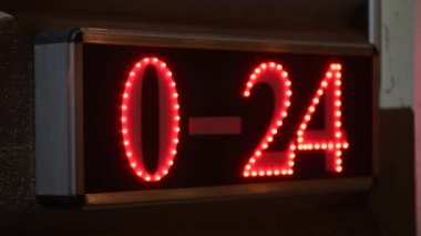 0-24 or 24-7 service, non-stop open business hours illuminated sign board at night on the street