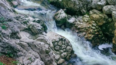 Cinemagraph of mountain river stream, cold freshwater running over rocks and stones