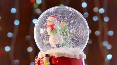 Snowman in Christmas glass ball, selective focus