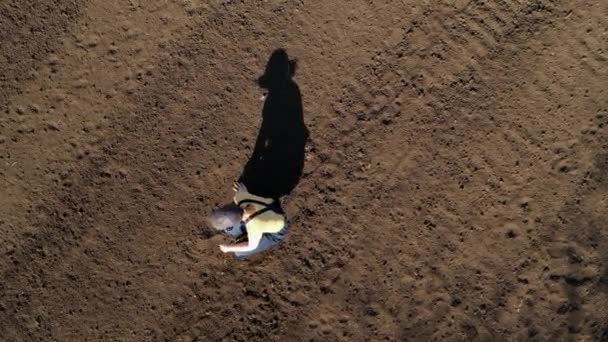 Female Farmer Examining Ploughed Field Soil Drone Footage Top View — Stock Video