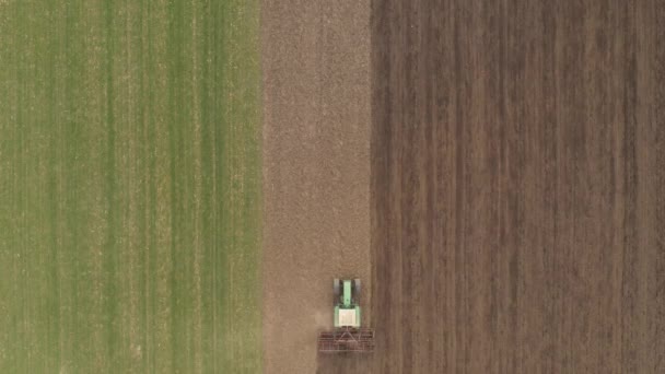 Aerial View Agricultural Tractor Tilling Harrowing Ploughed Field Directly Drone — Stock Video