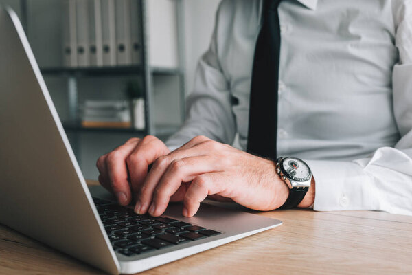 Professional accountant and tax adviser working on laptop computer in business office, selective focus