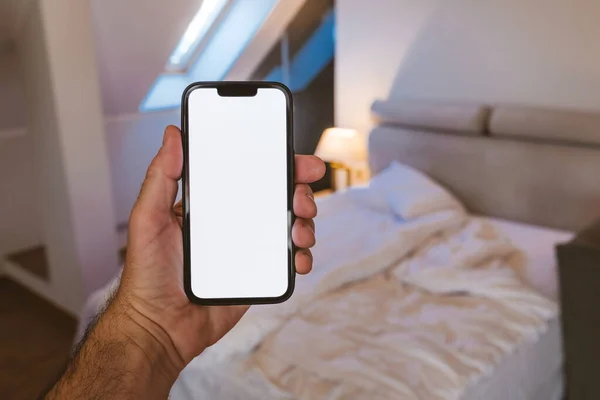 Smartphone mockup screen, man using mobile phone in bedroom, selective focus