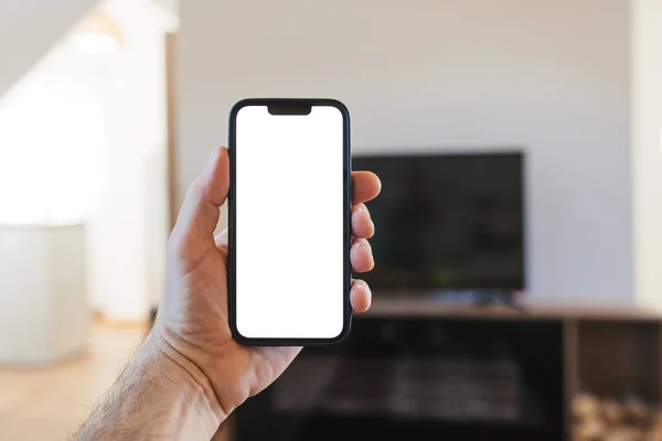 Man Met Smartphone Met Blank Wit Mockupscherm Voor Flatscreen Selectieve — Stockfoto