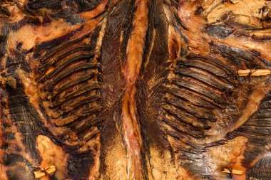 Whole flattened cured air-dried and smoked goat meat