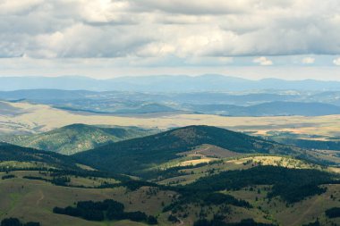View of Zlatibor hills and valleys seen from the Tornik mountain top on sunny summer day