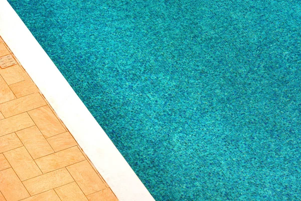 Outdoor swimming pool water as abstract summer season background, high angle view