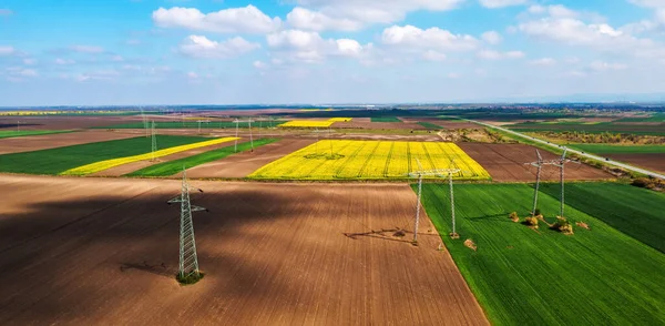 Aerial Shot Transmission Towers Electricity Pylons Power Lines Cultivated Agricultural — Foto de Stock