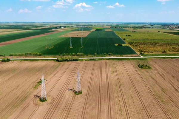 Electricity Pylon Transmission Towers Power Lines Cultivated Field Drone Pov — Zdjęcie stockowe