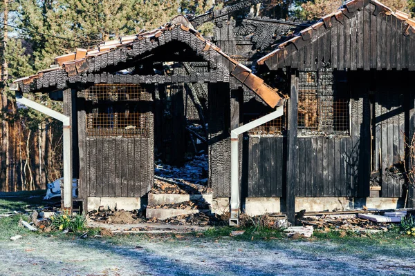 Detail of burnt wooden structure of a house after the fire blaze, selective focus