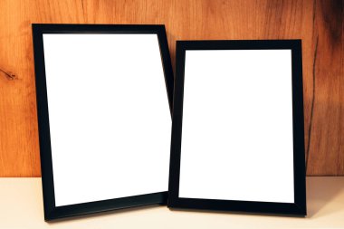 Two blank picture frames on the shelf as mockup copy space for graphic or text