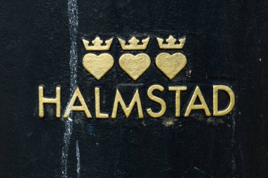 Halmstad, Sweden - August 20, 2022: Halmstad city logo on public trash can. Illustrative editorial.