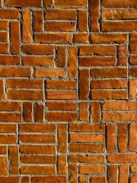 Intricate brick laying pattern as background, unusual brick wall texture