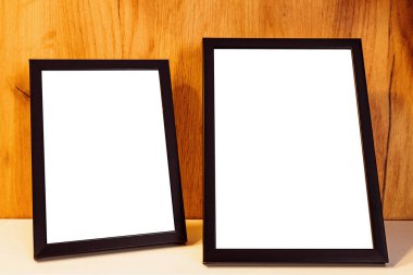 Two blank picture frames on the shelf as mockup copy space for graphic or text