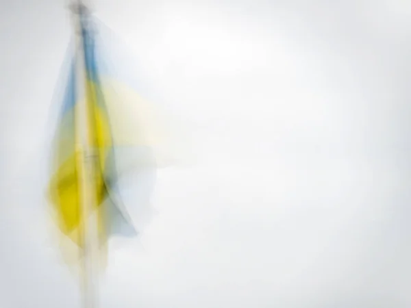 Ukraine national flag hanging in light breeze. Impressionist effect with copyspace. Imagem De Stock