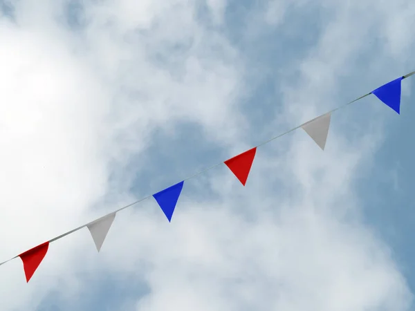 Photo of red white and blue triangular bunting on sky background. Queens Jubilee 2022. Imagens Royalty-Free