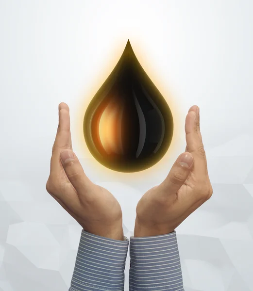 Open hands with drop of oil — Stock Photo, Image