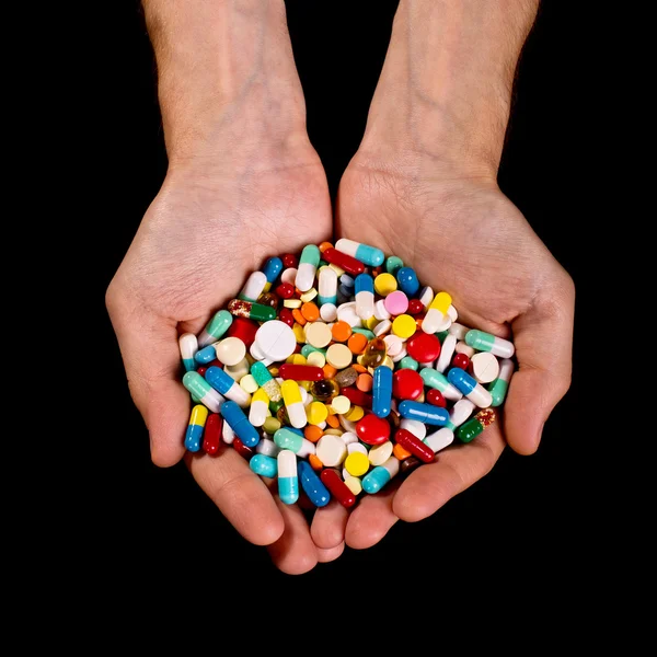 Handen vol van pillen — Stockfoto