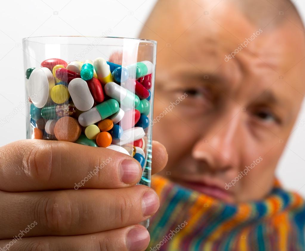 Man drinking pills