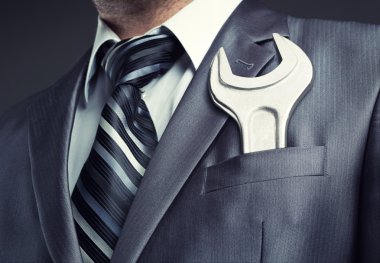Businessman with spanner clipart