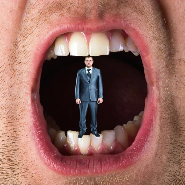 Businessman in open mouth — Stock Photo, Image