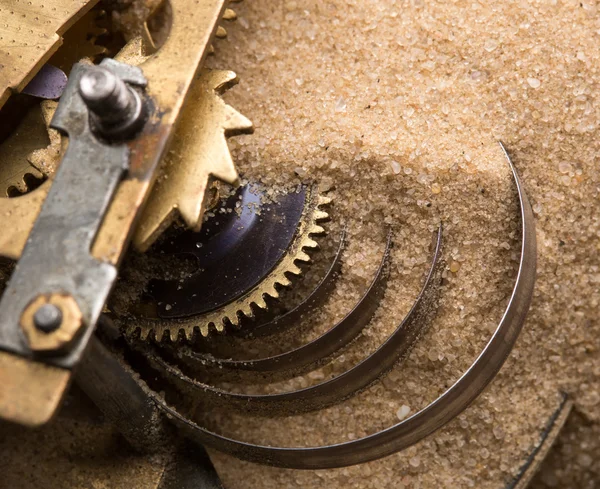 Clock gears in sand — Stock Photo, Image