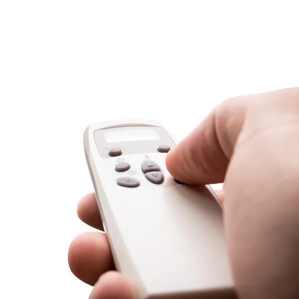 Hand holding remote control Stock Photo