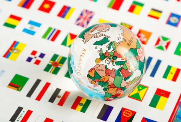 Glass globe on the flags — Stock Photo, Image