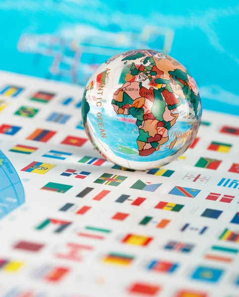 Glass globe on the flags — Stock Photo, Image