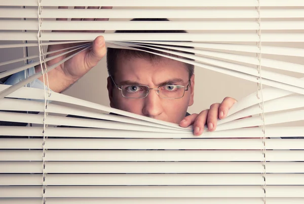 Man and window blinds — Stock Photo, Image