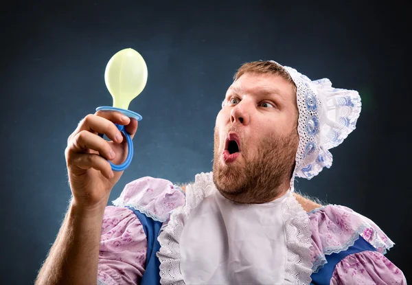 Man with a pacifier in hand — Stock Photo, Image