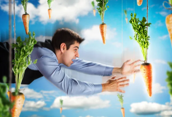 Empresario volando con zanahorias — Foto de Stock