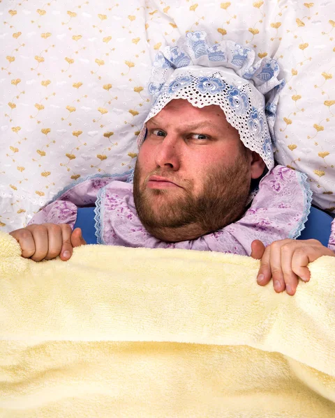 Man weared as baby angry in bed — Stock Photo, Image