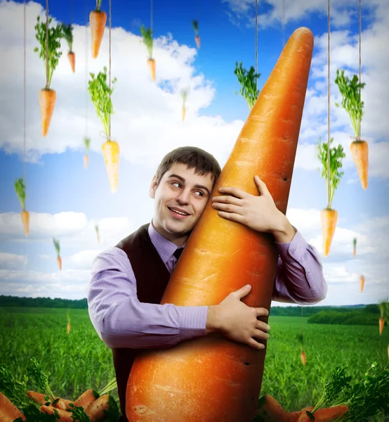 Huge carrot and man — Stock Photo, Image
