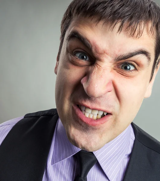 Businessman making faces — Stock Photo, Image