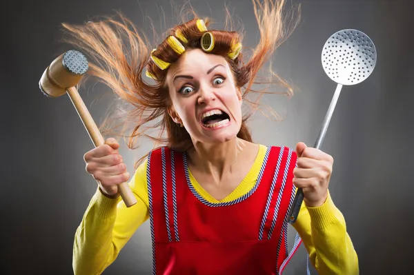 Crazy housewife with kitchen tools — Stock Image Crazy housewife with kitchen tools Royalty Free Stock Images